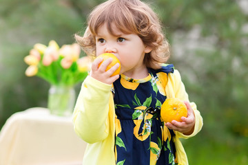 toddler girl eating lemons