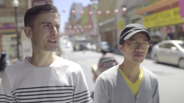 Happy Gay Couple Explore Chinatown, San Francisco, They See Something Funny And Laugh 