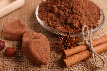 Chocolate heart-shaped candy on a rustic background, chocolate composition