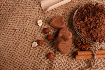 Chocolate heart-shaped candy on a rustic background, chocolate composition