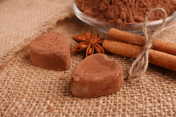 Chocolate heart-shaped candy on a rustic background, chocolate composition