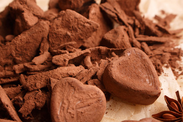 Chocolate heart-shaped candy on a rustic background, chocolate composition