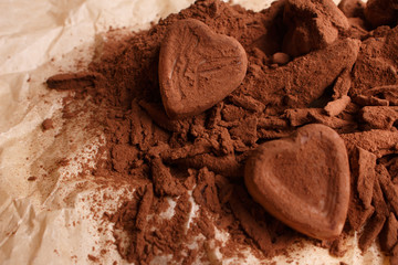 Chocolate heart-shaped candy on a rustic background, chocolate composition
