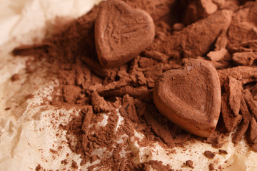 Chocolate heart-shaped candy on a rustic background, chocolate composition
