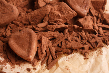 Chocolate heart-shaped candy on a rustic background, chocolate composition