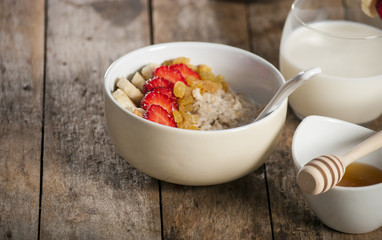 oatmeal porridge with strawberry and banana in a bowl