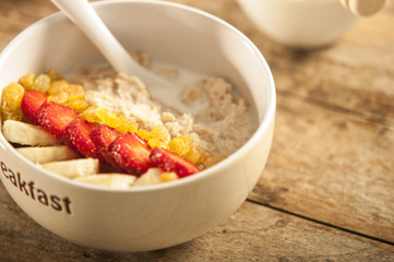 oatmeal porridge with strawberry and banana in a bowl