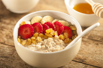oatmeal porridge with strawberry and banana in a bowl