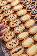 Woman hand decorating mini tarts