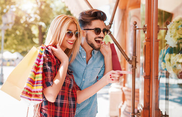 Shopping time. Young couple in shopping. Consumerism, love, dating, lifestyle concept