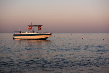 Naklejka premium Boat on Mediterranean sea at dawn.