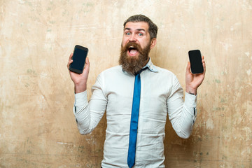 businessman or bearded man compare mobile phone and smartphone