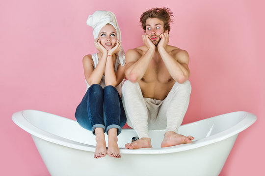 young beautiful couple in love sitting on bath