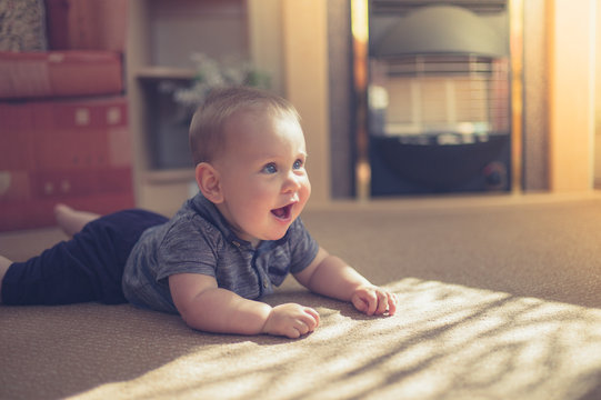 Cute baby crawling on carpet in the sun