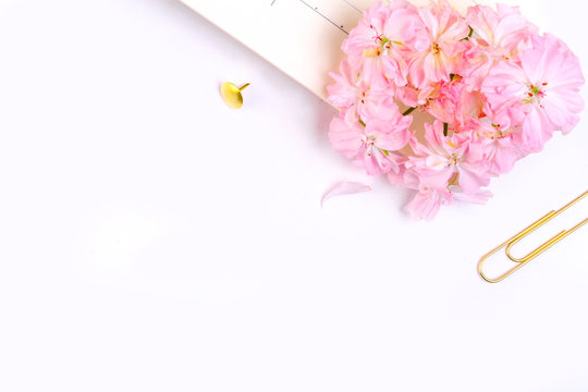 Workplace mockup with pink leather notebook and golden accessories on white background top view. Flat lay with copy space.  Feminine working style concept.