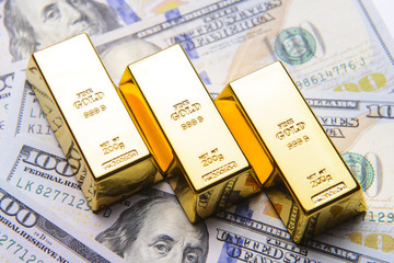 Gold bar with american hundred dollar bills