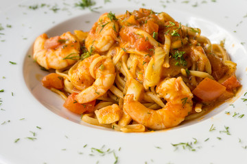 close-up of plate of pasta and Shrimp with lettuce