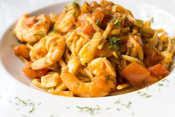 close-up of plate of pasta and Shrimp with lettuce
