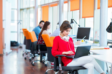 Fototapeta premium business, startup, people and teamwork concept - happy young woman over creative team in office
