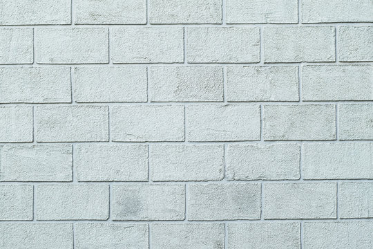 Photo texture of the plastered textured wall in the form of brick blocks of white color. Concrete block wall