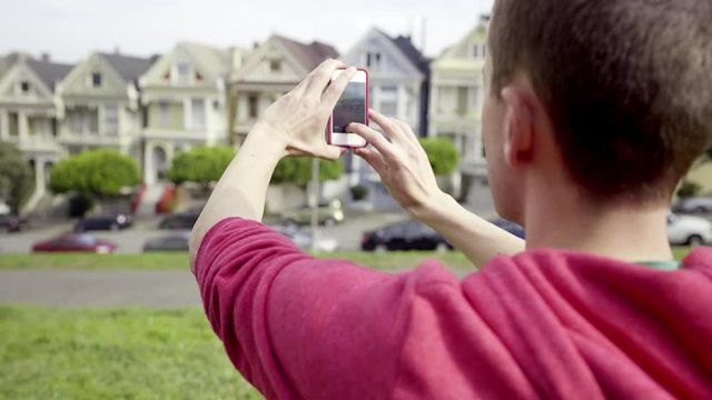 Tourist Takes A Photo Of The Painted Ladies In San Francisco