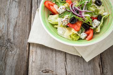 Greek salad with fresh vegetables, feta cheese and black olives