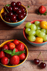 Three plates of summer fruit.