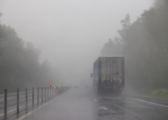 Poor visibility on the highway. Truck in the fog