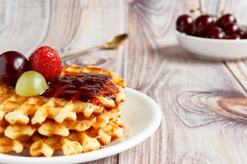 Tasty and healthy breakfast: waffles with fruit jam