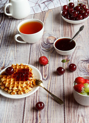 Tasty and healthy breakfast: waffles with fruit jam