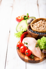 Raw chicken and fresh vegetables on a table. Healthy food. Selective focus. Copy space