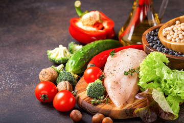 Raw chicken and fresh vegetables on a table. Healthy food. Selective focus. Copy space