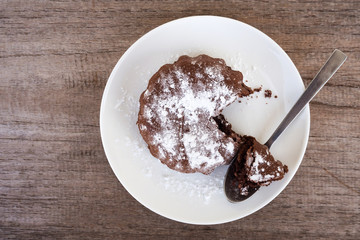 Fresh homemade chocolate cake on white plate. Top view.
