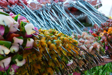 assorted skewers with meat, fish and vegetables on market in morocco