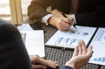 two Business Executives discussing sales performance in a workplace.