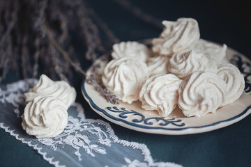 White marshmallow with dried lavender on a plate with a blue pattern