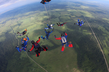 The team of skydivers is in the sky