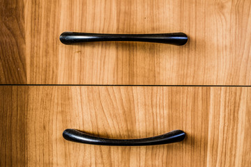 Furniture handle on wooden background