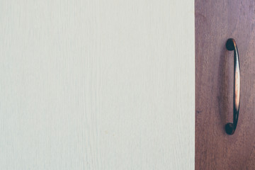 Furniture handle on wooden background