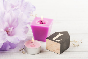 Flowers and wooden letter L on white table