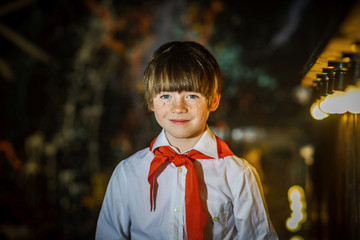 Redhead attractive boy dressed like soviet pioneer with red tie