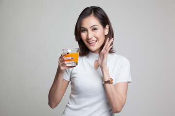 Happy Young Asian woman drink orange juice.