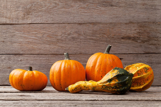 Autumn pumpkins on wooden board table