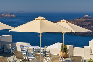Fototapeta na wymiar Patio umbrellas and ocean views in Santorini, Greece