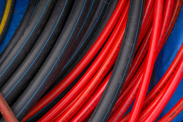 Water garden and high pressure hoses red, black and blue colors. Close-up.
