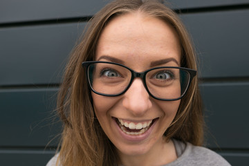 Large portrait of a girl with glasses on a gray background
