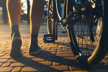 Closeup Of Male Feet And City Bicycle Wheels, Rear View And Low Angle Holiday Weekend Activity