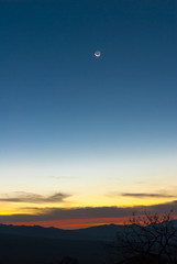 Sunrise clouds and mountains in Guatemala, dramatic sky with striking colors and moon. La Reunion.