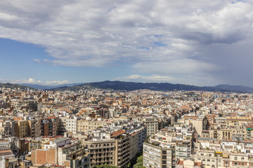 Barcelona skyline with hills and dark clouds coming from the right