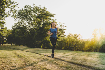 Young woman running, jogging in the park. Exercising outdoor